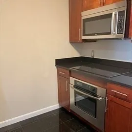 a stove top oven sitting inside of a kitchen