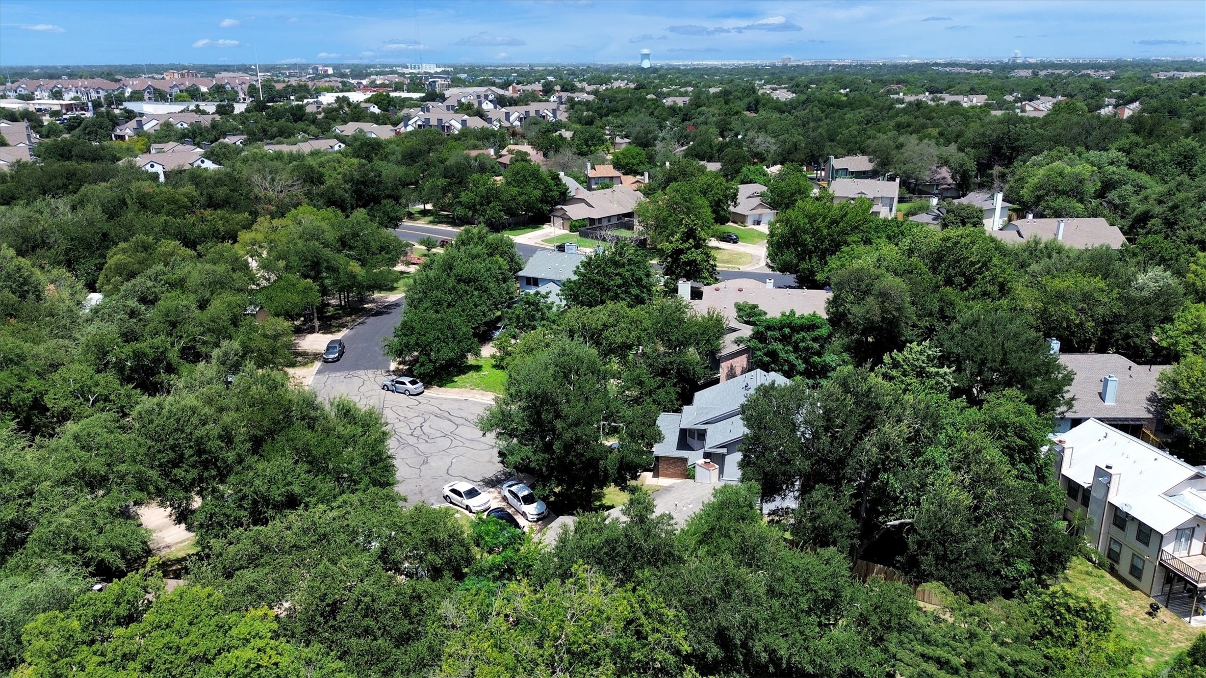 7802 Topawa Cove, Unit B Austin, TX 78729 - Photo 31 of 32 An aerial perspective reveals a verdant neighborhood with established homes nestled among a canopy of mature trees.