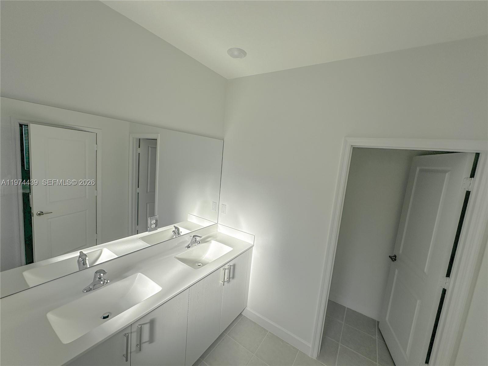 14804 Southwest 162nd Street Miami, FL 33177 - Photo 12 of 22 a bathroom with a sink and a mirror