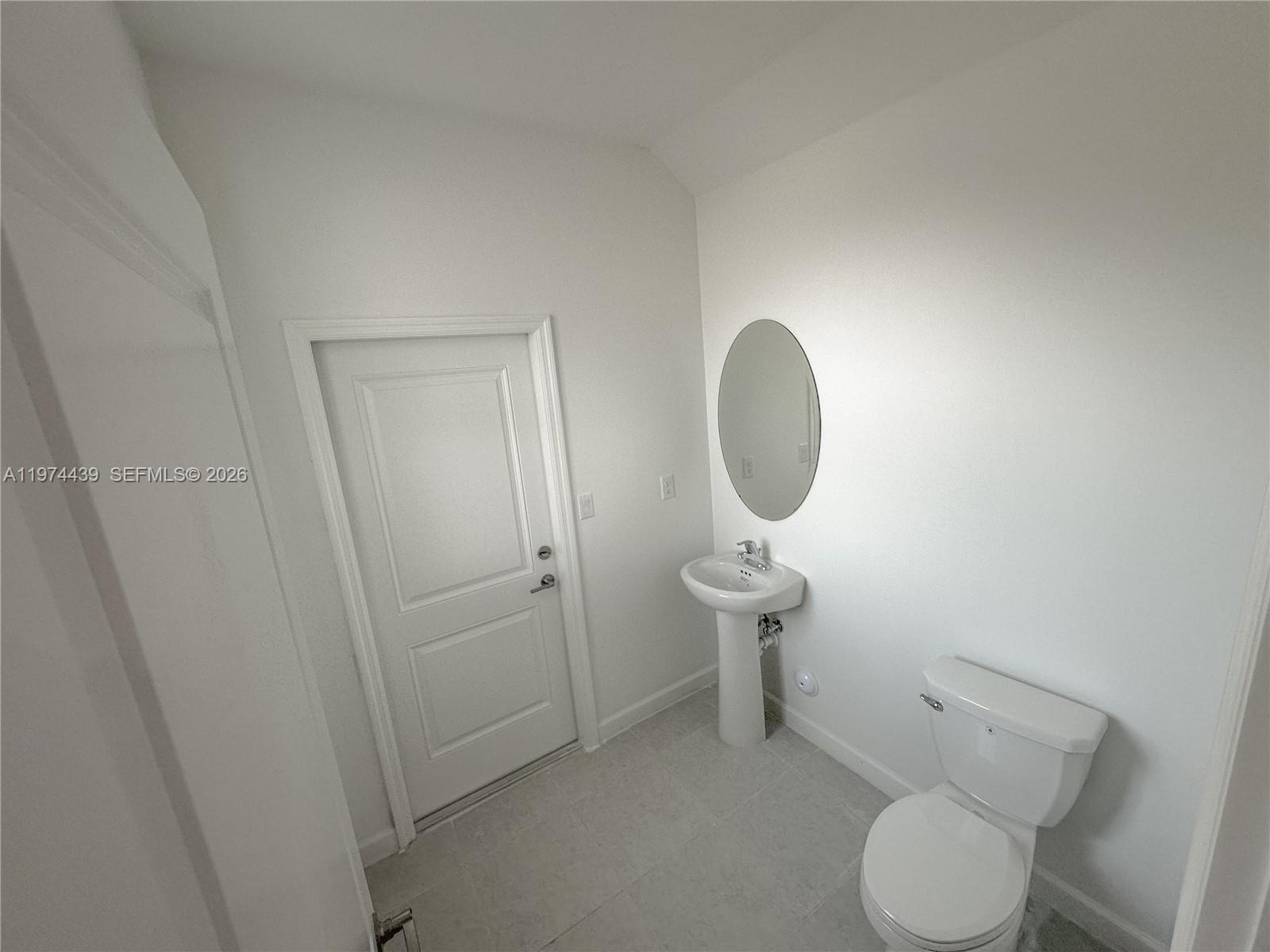 14804 Southwest 162nd Street Miami, FL 33177 - Photo 20 of 22 a white toilet sitting next to a bathroom sink