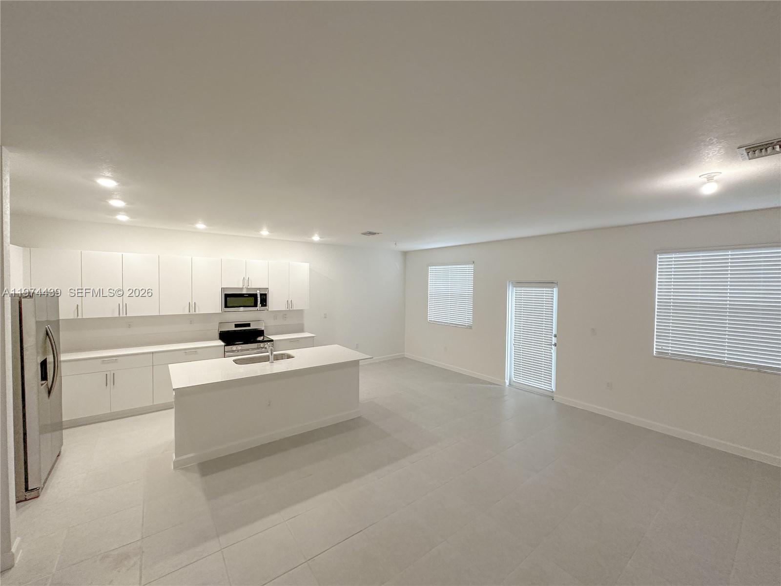 14804 Southwest 162nd Street Miami, FL 33177 - Photo 6 of 22 a view of kitchen with stove and refrigerator