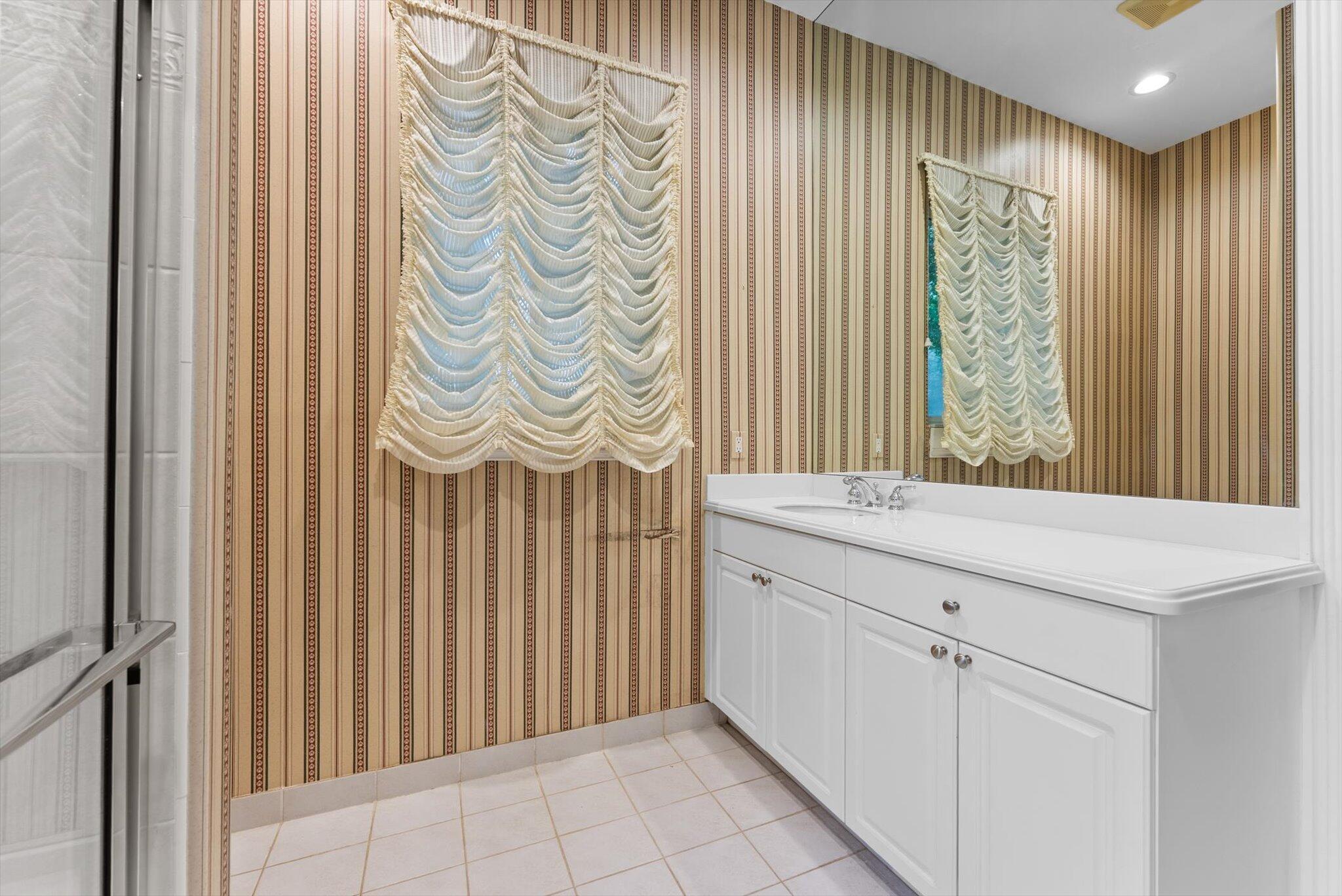 7081 Mallorca Crescent Boca Raton, FL 33433 - Photo 16 of 26 a bathroom with a sink and a mirror