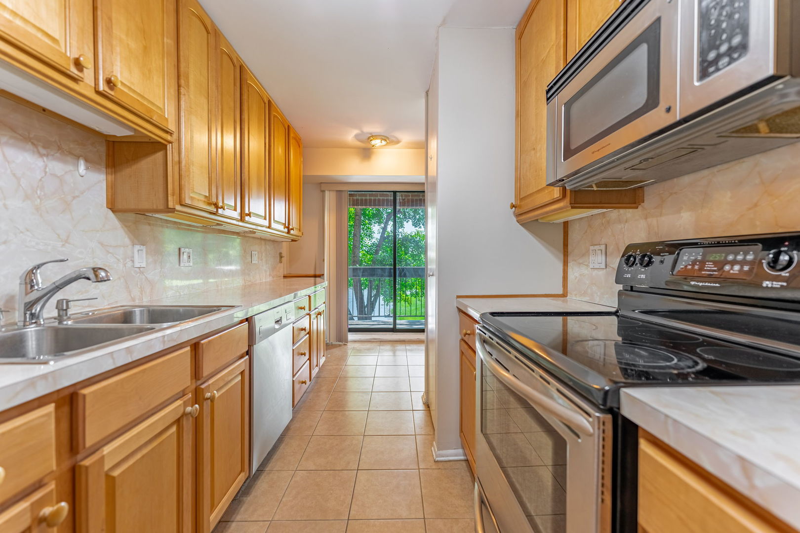 701 Forum Square, Unit 101 Glenview, IL 60025 - Photo 11 of 42 a kitchen with stainless steel appliances granite countertop a sink and a stove