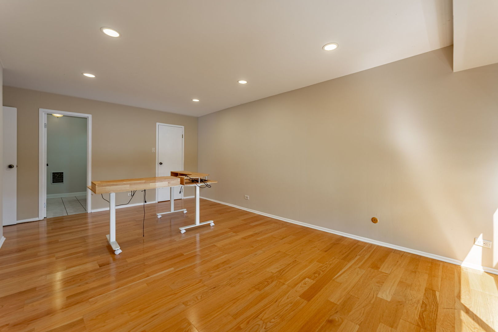 701 Forum Square, Unit 101 Glenview, IL 60025 - Photo 13 of 42 a room with wooden floor and glass door