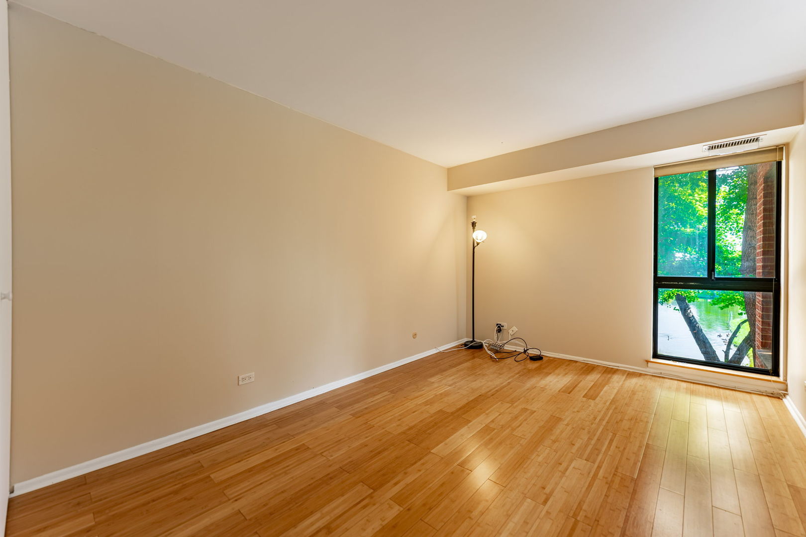 701 Forum Square, Unit 101 Glenview, IL 60025 - Photo 17 of 42 wooden floor in an empty room with a window