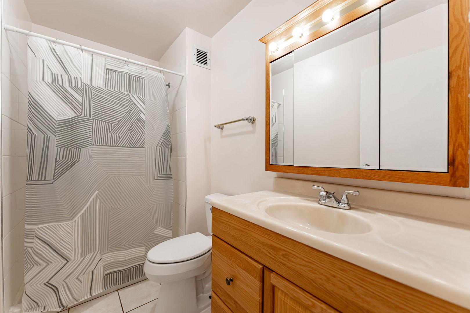 701 Forum Square, Unit 101 Glenview, IL 60025 - Photo 19 of 42 a bathroom with a sink a toilet and shower
