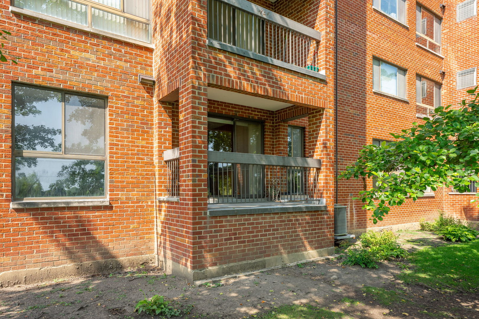 701 Forum Square, Unit 101 Glenview, IL 60025 - Photo 25 of 42 a view of a brick house with many windows