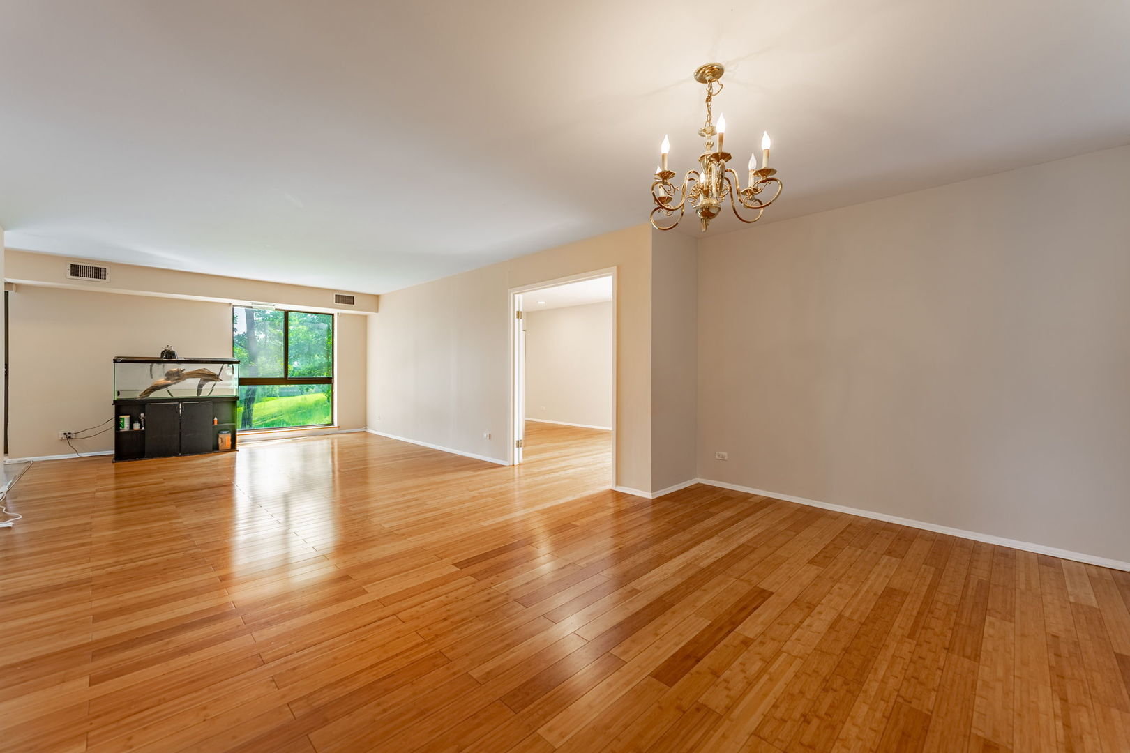 701 Forum Square, Unit 101 Glenview, IL 60025 - Photo 5 of 42 a view of empty room with wooden floor and fireplace