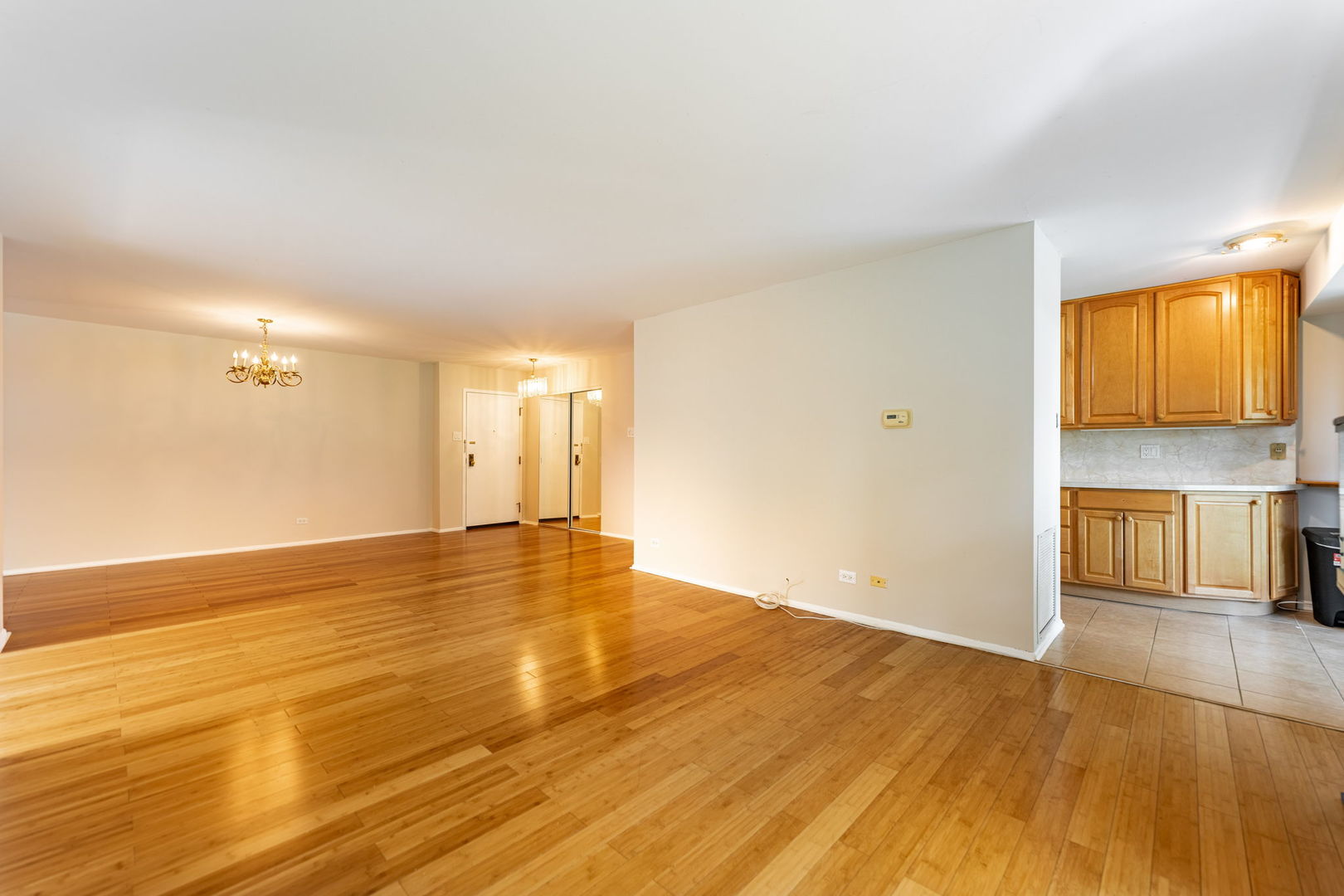 701 Forum Square, Unit 101 Glenview, IL 60025 - Photo 7 of 42 a view of empty room with wooden floor and fan