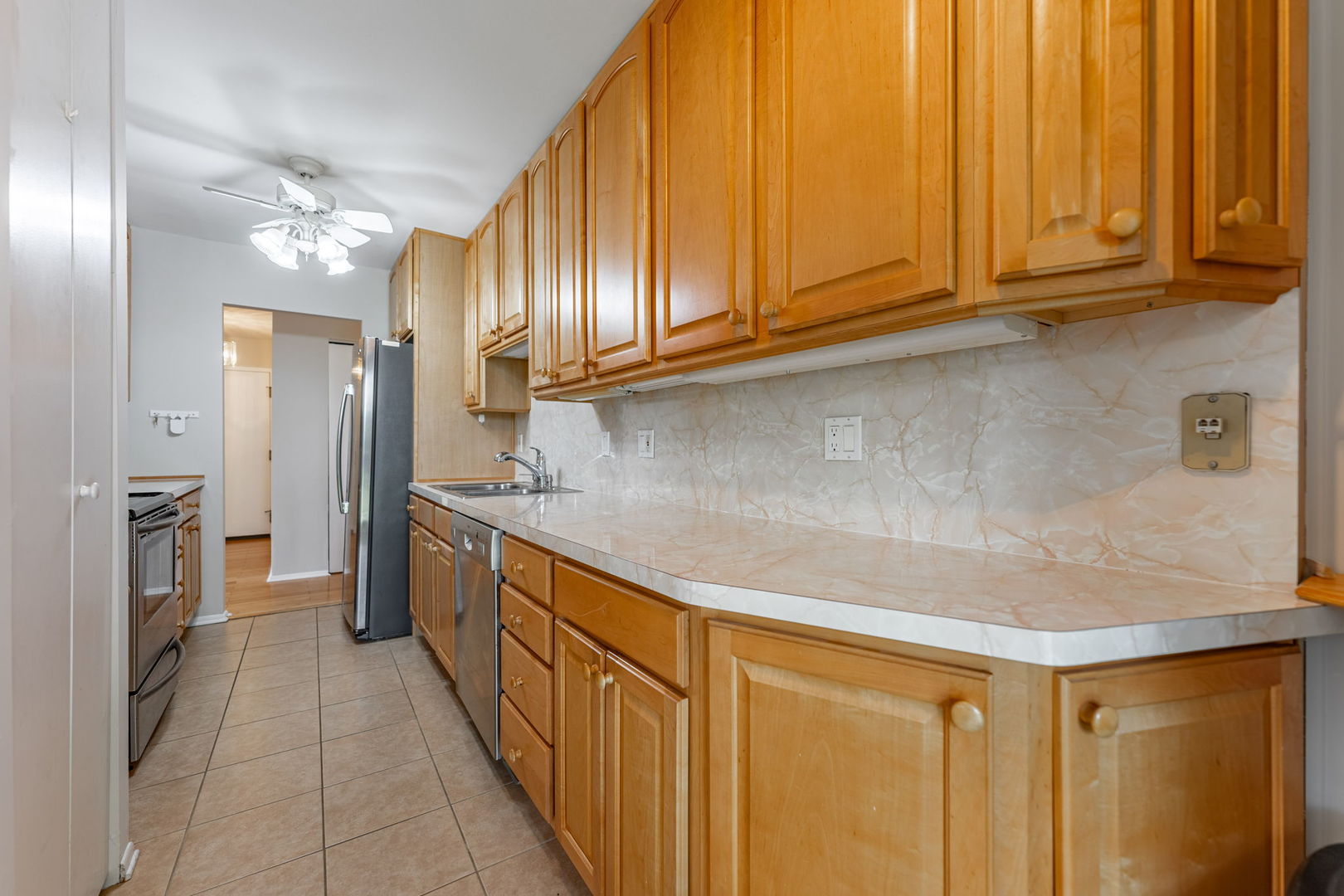 701 Forum Square, Unit 101 Glenview, IL 60025 - Photo 9 of 42 a kitchen with stainless steel appliances granite countertop a sink a stove and a refrigerator