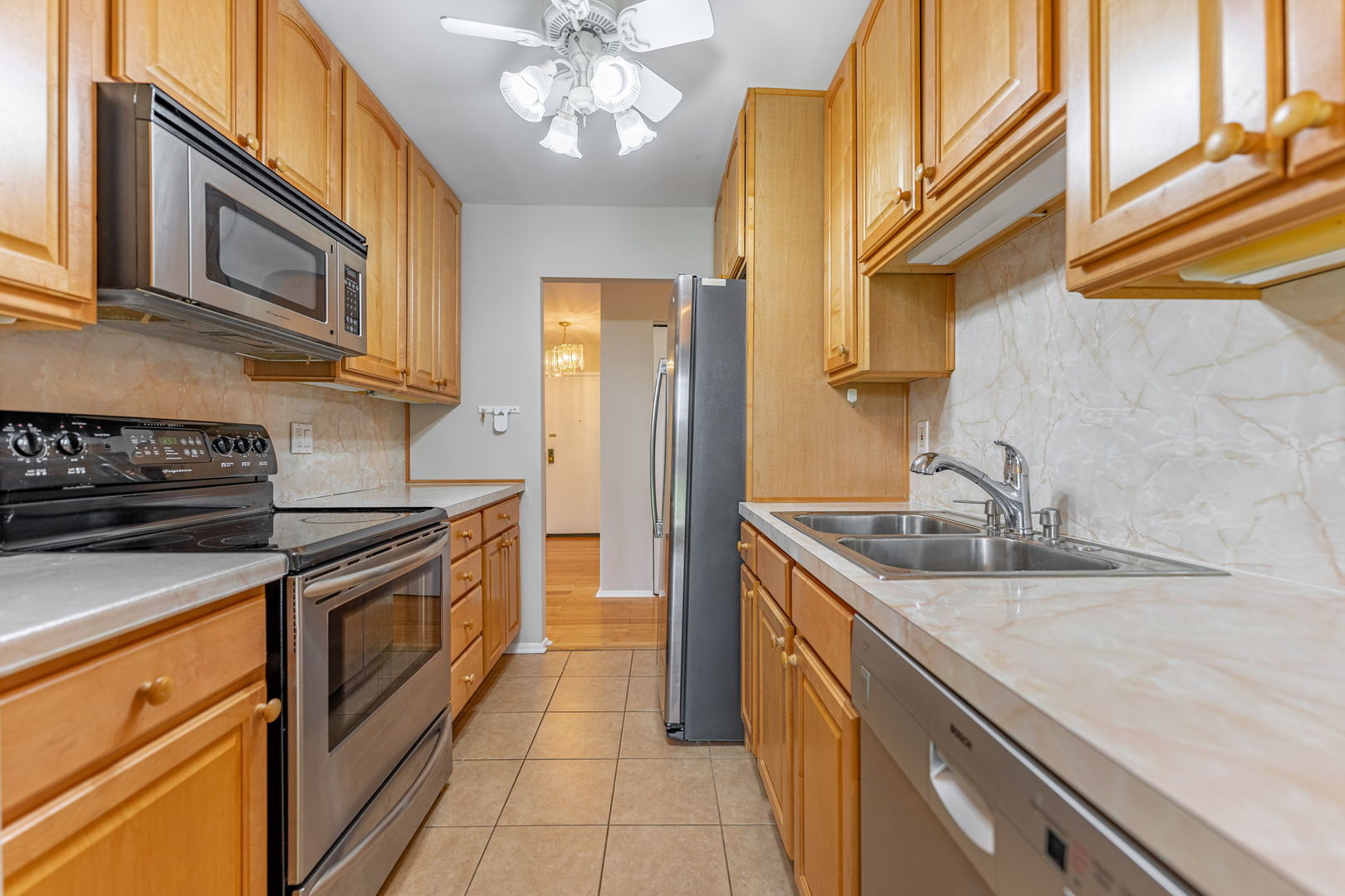701 Forum Square, Unit 101 Glenview, IL 60025 - Photo 10 of 42 a kitchen with stainless steel appliances granite countertop a sink and cabinets