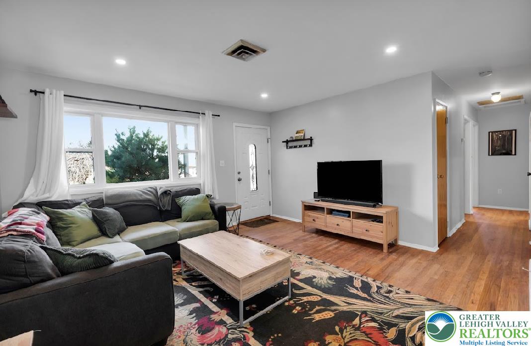 856 Poplar Road Hellertown, PA 18055 - Photo 4 of 19 a living room with furniture and a flat screen tv