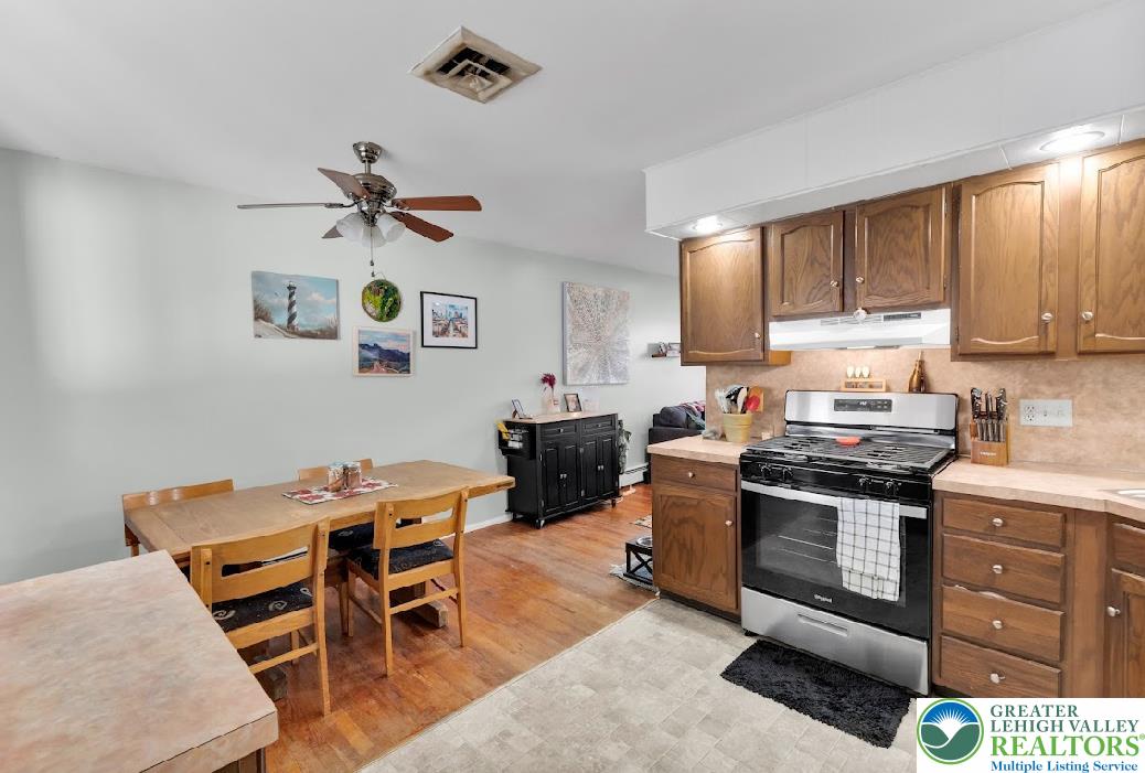 856 Poplar Road Hellertown, PA 18055 - Photo 6 of 19 a kitchen with stainless steel appliances kitchen island granite countertop a stove top oven a sink a dining table and chairs