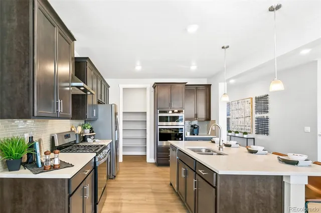 a kitchen with a sink stove and refrigerator