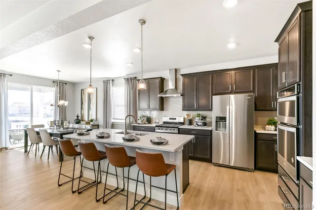 a kitchen with kitchen island a large counter top space appliances and cabinets