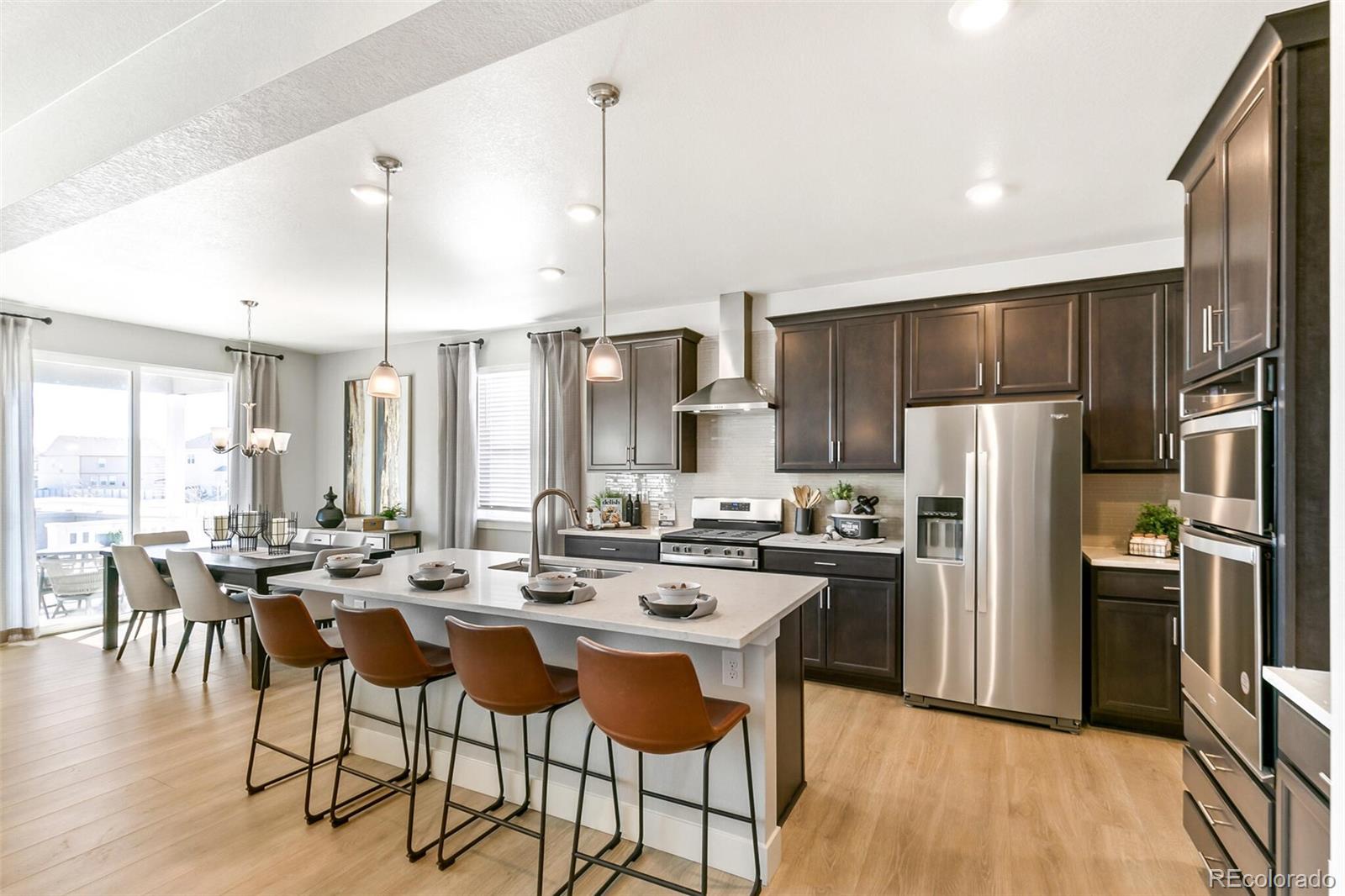 1908 Chaffee Crest Drive Berthoud, CO 80513 - Photo 14 of 39 a kitchen with kitchen island a large counter top space appliances and cabinets