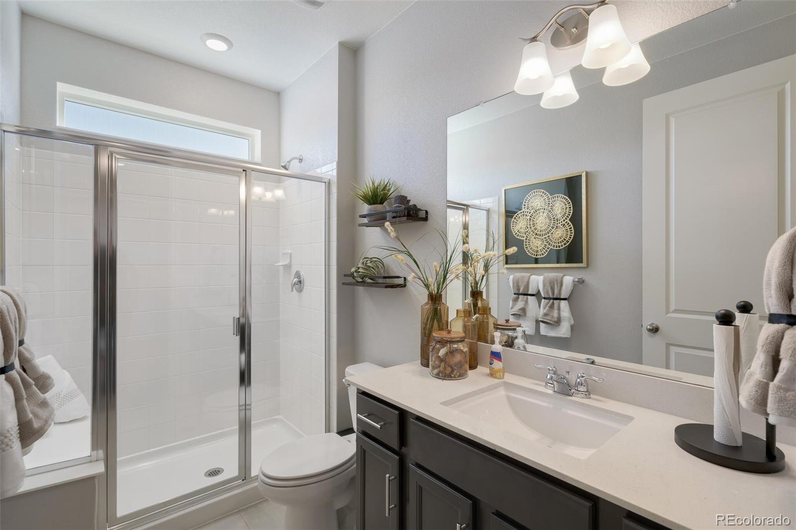 1908 Chaffee Crest Drive Berthoud, CO 80513 - Photo 17 of 39 a bathroom with a granite countertop sink toilet and shower