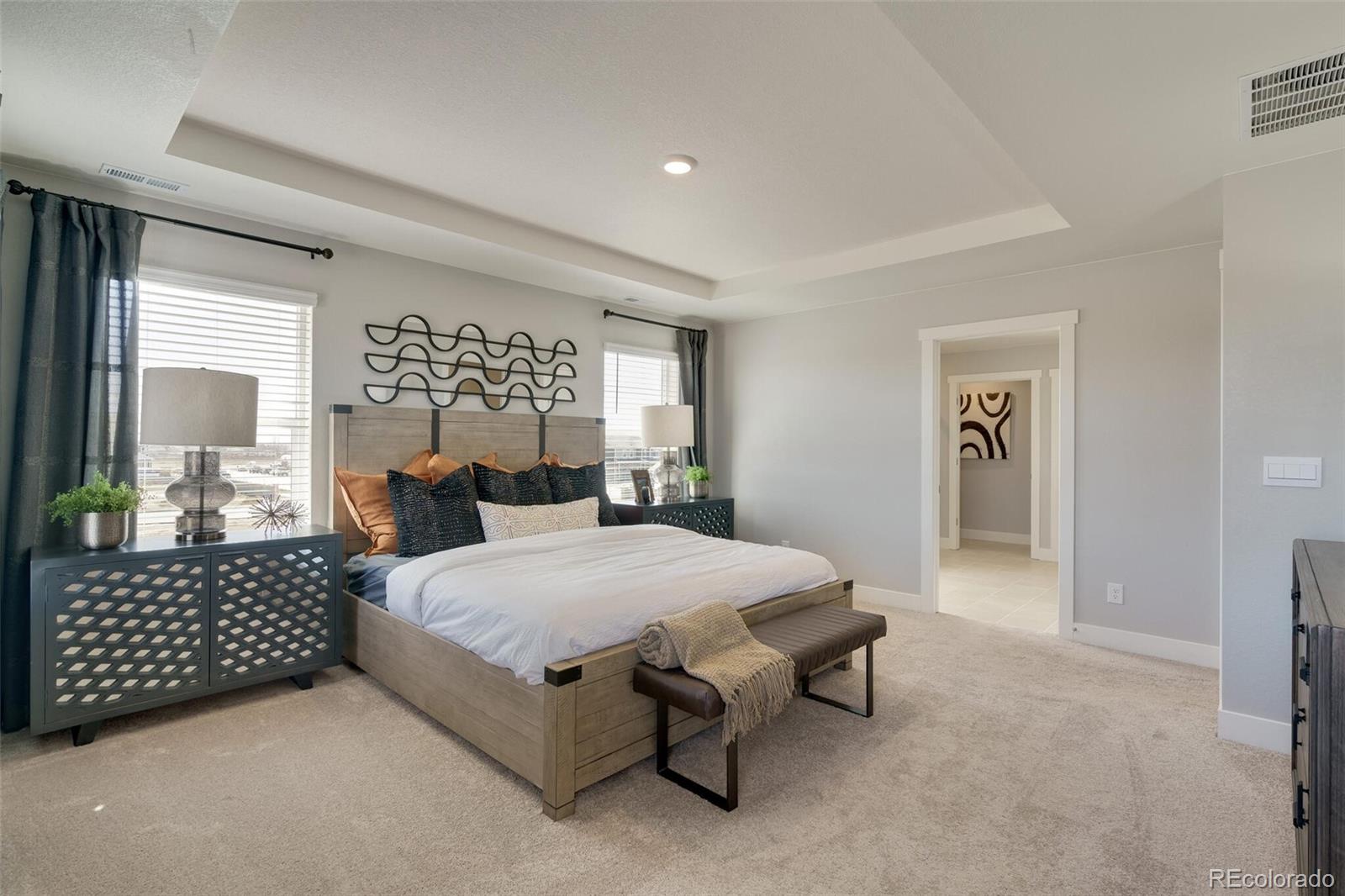 1908 Chaffee Crest Drive Berthoud, CO 80513 - Photo 20 of 39 a spacious bedroom with a bed and dresser