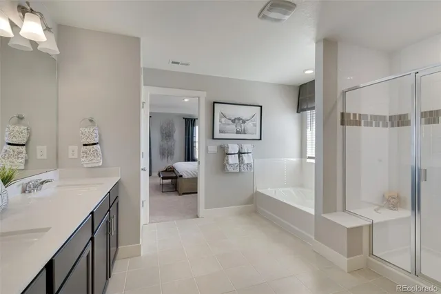 a bathroom with a tub sink and mirror