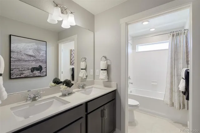 a bathroom with a tub a sink and mirror