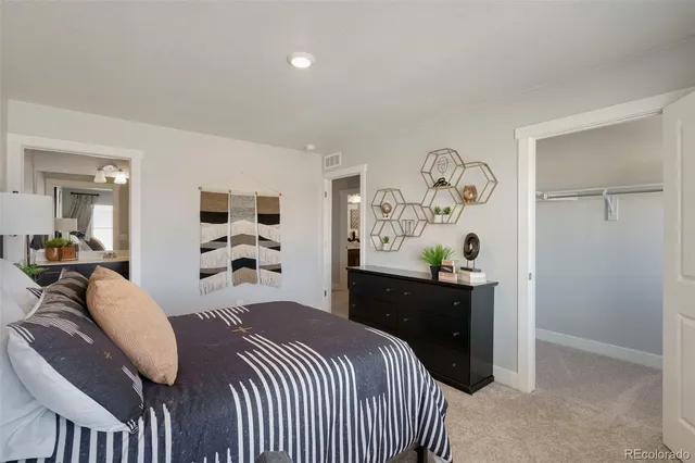 a bedroom with a bed and dresser
