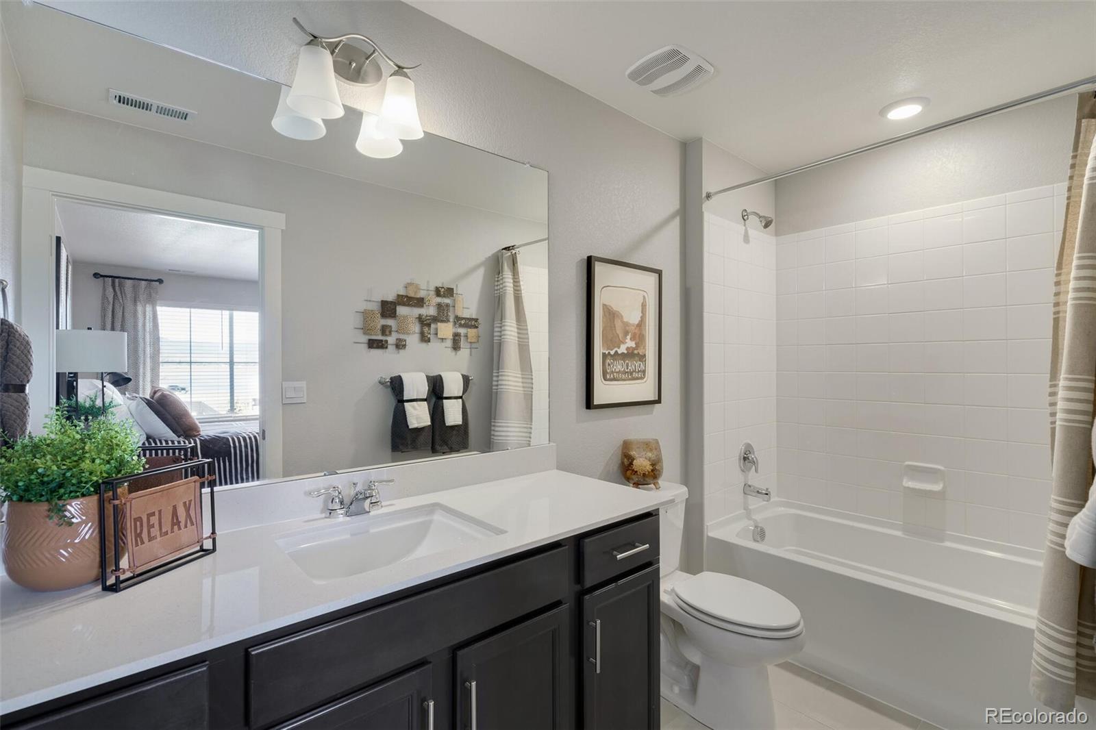 1908 Chaffee Crest Drive Berthoud, CO 80513 - Photo 28 of 39 a bathroom with a double vanity sink toilet and shower