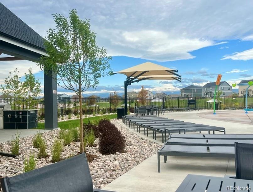 1908 Chaffee Crest Drive Berthoud, CO 80513 - Photo 35 of 39 a view of a patio with couches table and chairs under an umbrella