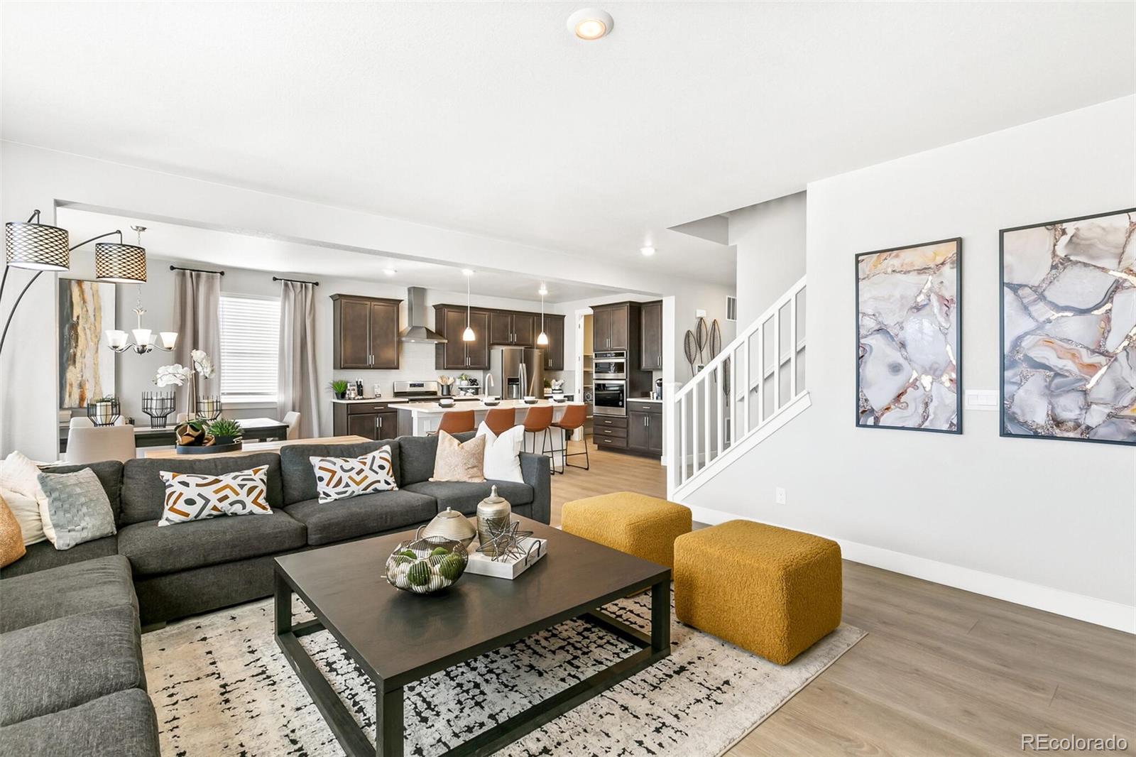 1908 Chaffee Crest Drive Berthoud, CO 80513 - Photo 5 of 39 a living room with furniture couches and a dining table with wooden floor