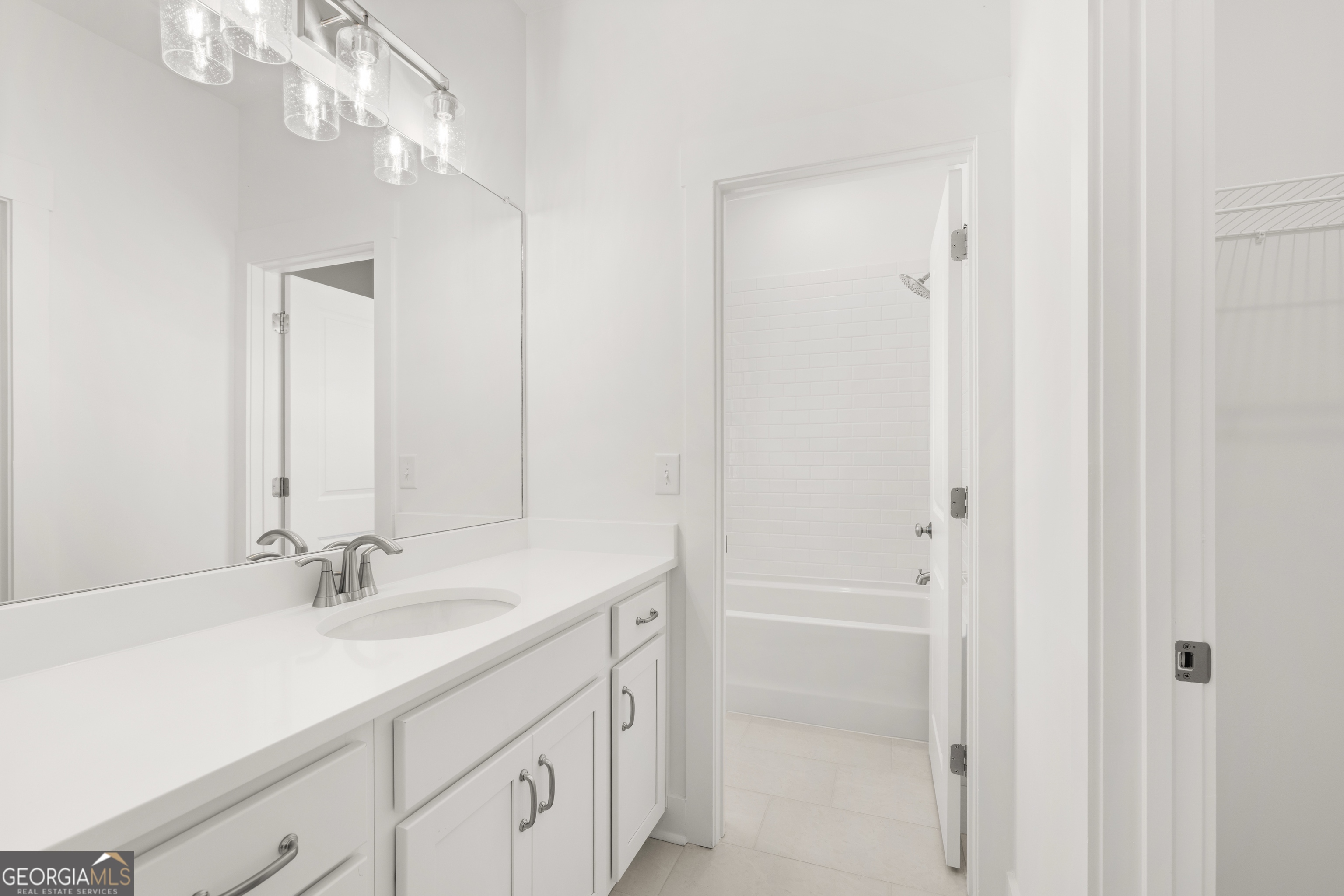 15 Overview Court Hoschton, GA 30548 - Photo 31 of 43 a bathroom with a sink vanity and a mirror