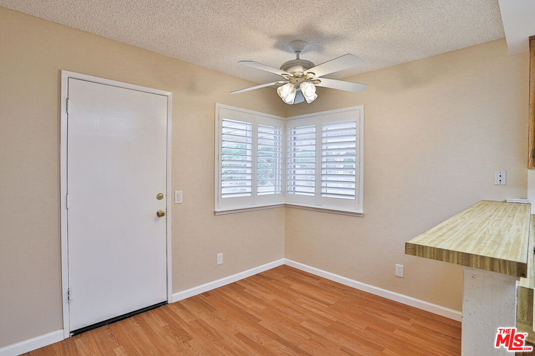 6811 Wilding Place Riverside, CA 92506 - Photo 12 of 42 a view of an empty room with a window and wooden floor