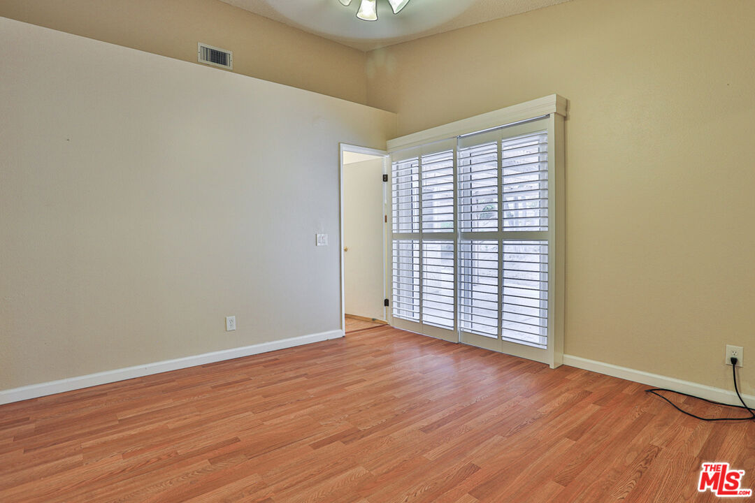 6811 Wilding Place Riverside, CA 92506 - Photo 15 of 42 an empty room with wooden floor and windows