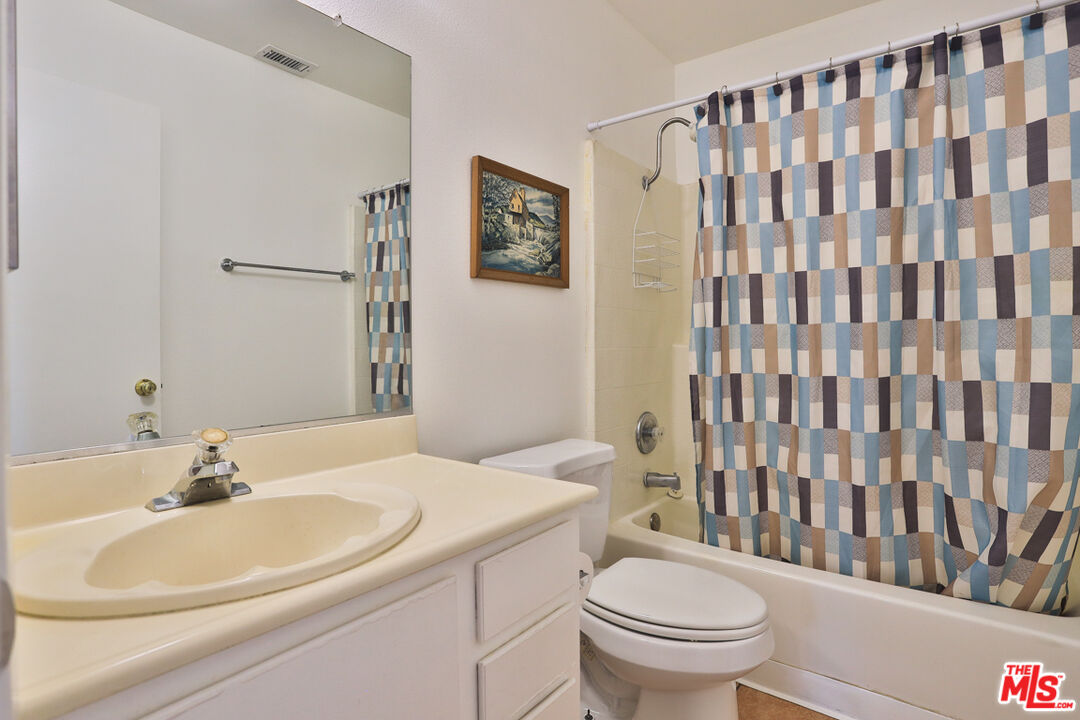 6811 Wilding Place Riverside, CA 92506 - Photo 21 of 42 a bathroom with a sink toilet and shower