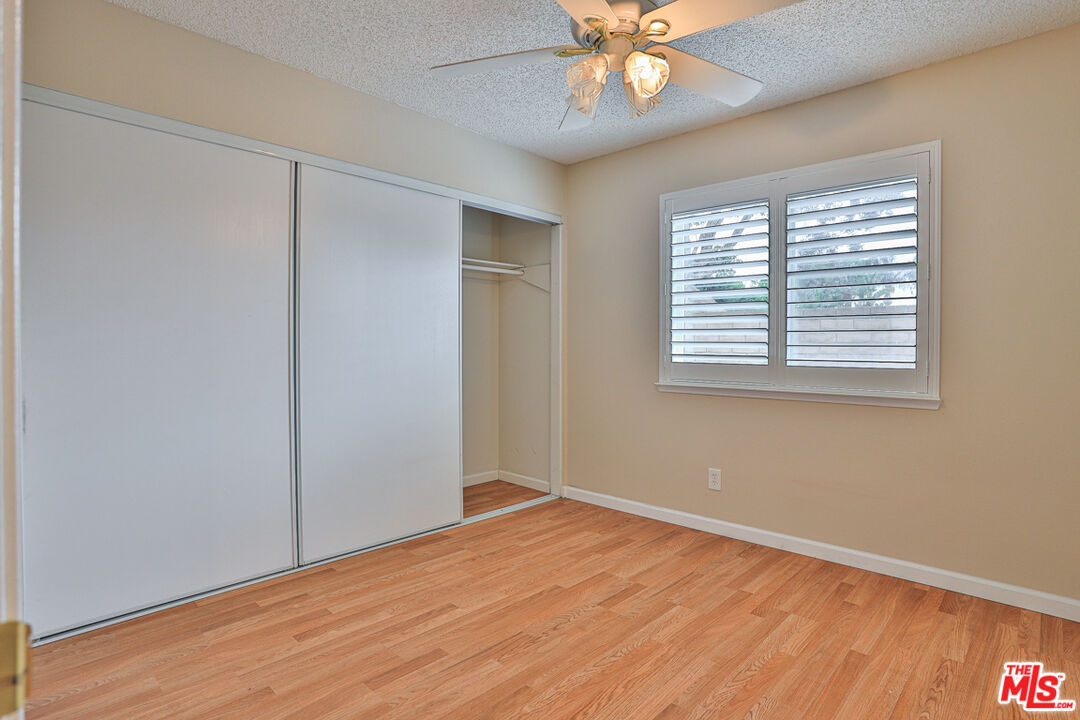 6811 Wilding Place Riverside, CA 92506 - Photo 24 of 42 a view of an empty room with wooden floor and a window