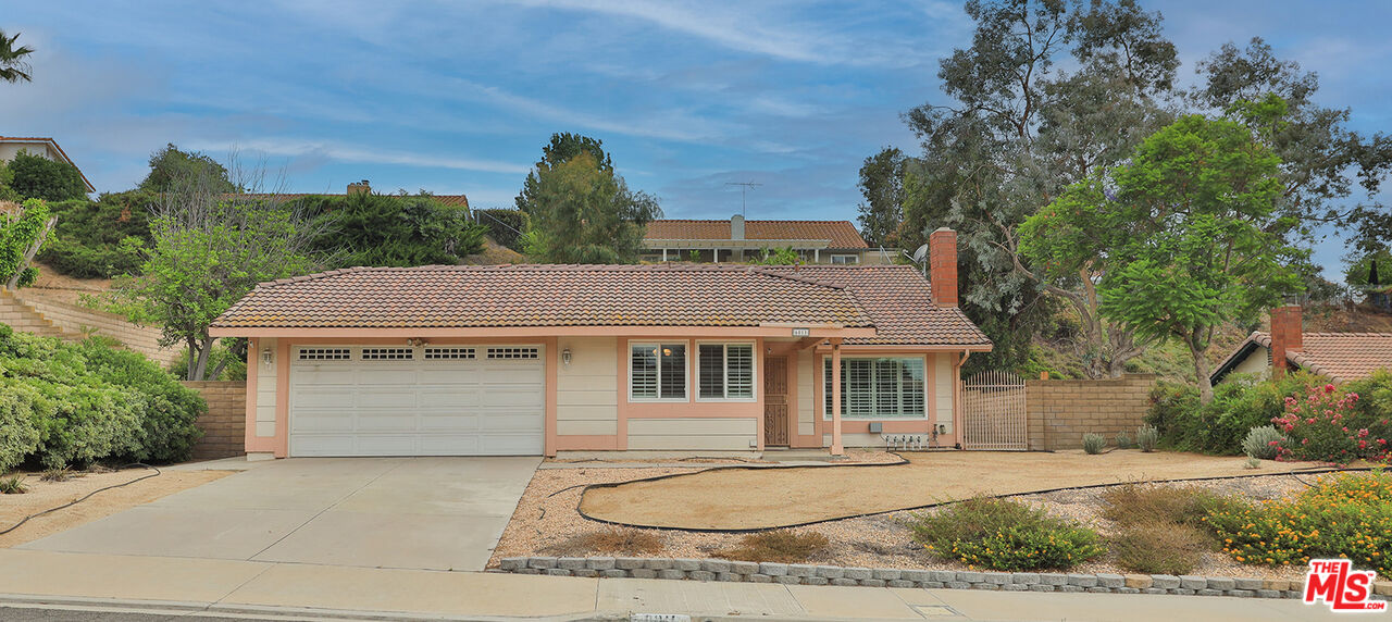6811 Wilding Place Riverside, CA 92506 - Photo 40 of 42 a front view of a house with a yard and garage