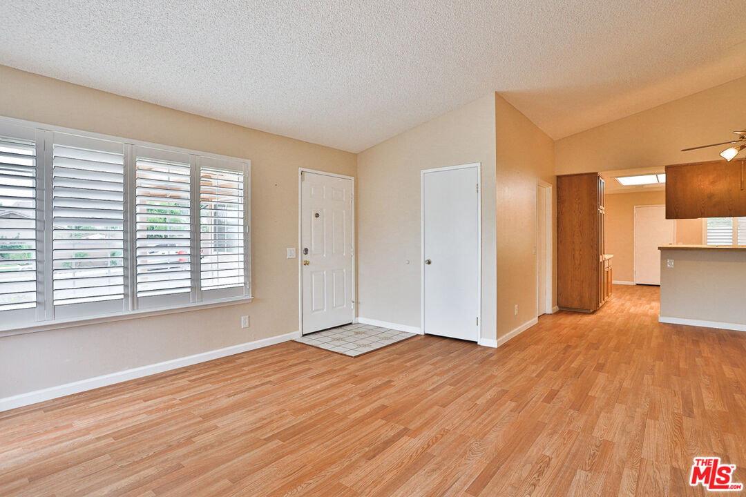 6811 Wilding Place Riverside, CA 92506 - Photo 6 of 42 a view of empty room with wooden floor and fan