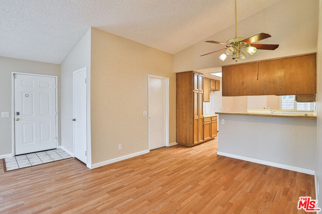 6811 Wilding Place Riverside, CA 92506 - Photo 8 of 42 a very nice looking room with wooden floor and a ceiling fan
