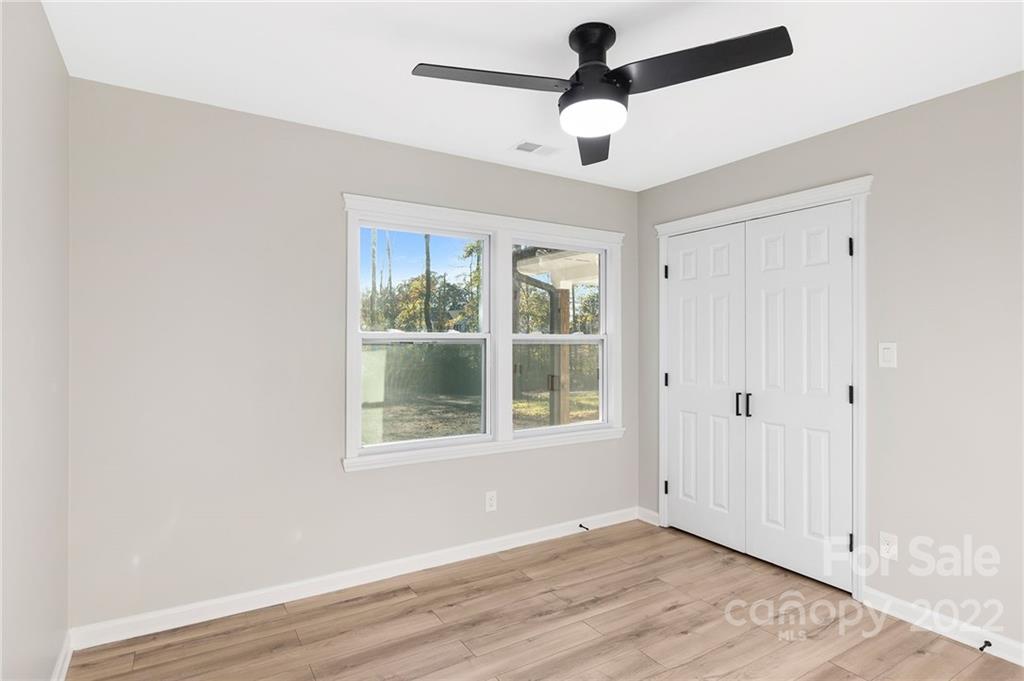 2606 Holbrook Road Fort Mill, SC 29715 - Photo 14 of 23 an empty room with wooden floor chandelier and windows