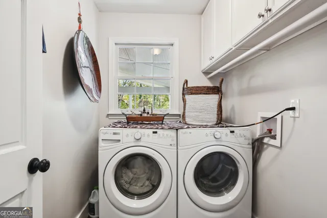 a view of a hallway with washer and dryer