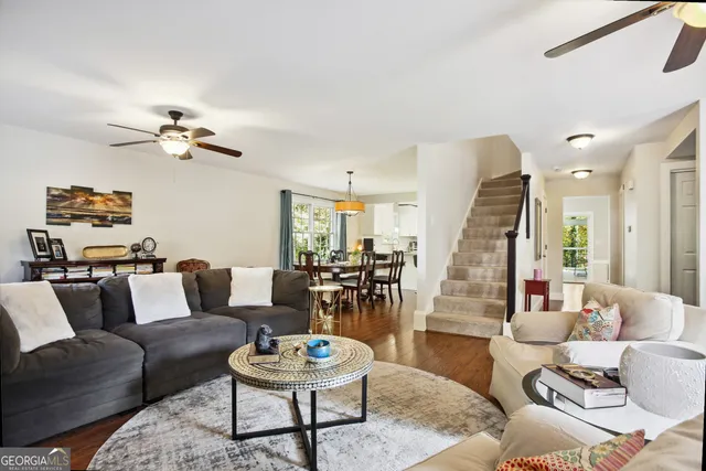 a living room with furniture and a chandelier