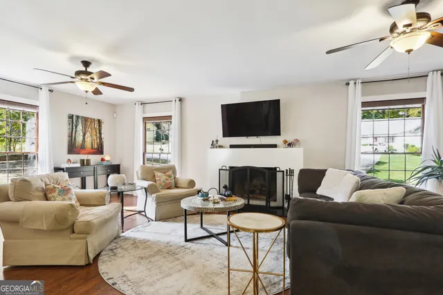 a living room with furniture a fireplace and a flat screen tv
