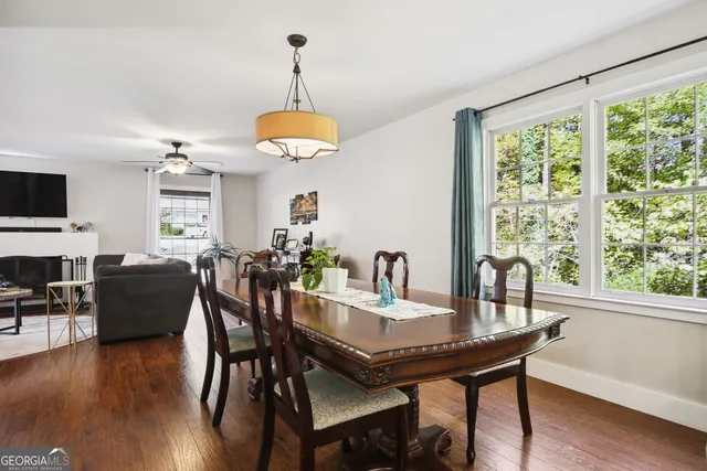 a view of a dining room with furniture window and wooden floor