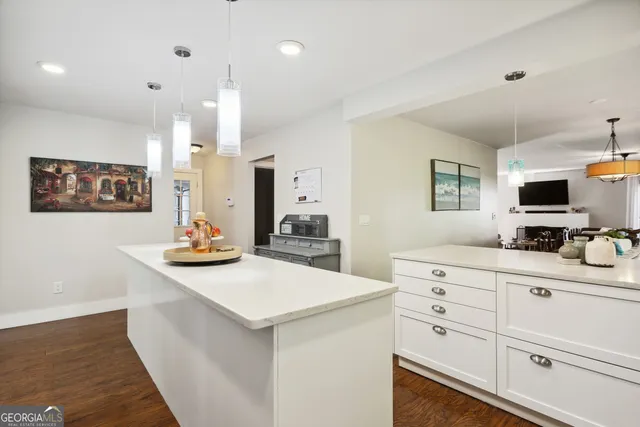 a kitchen with sink a stove and cabinets
