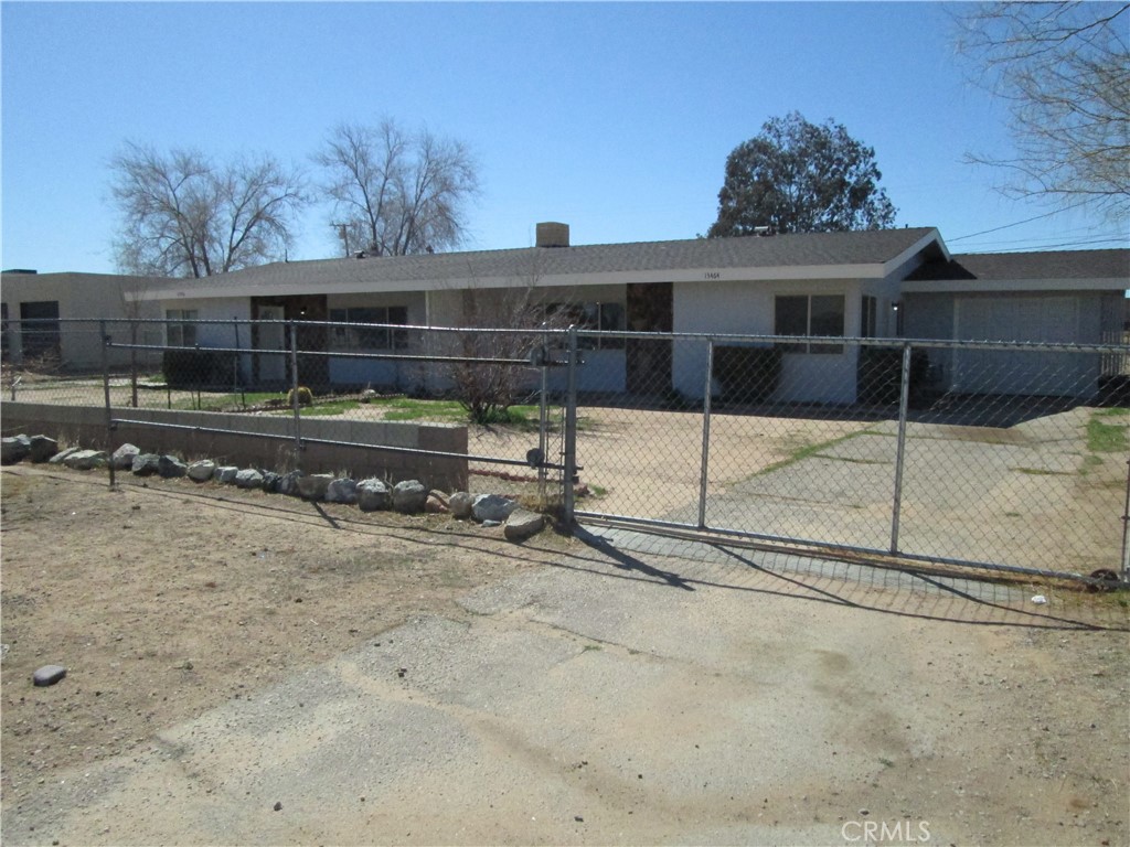 a view of a backyard with a wooden fence