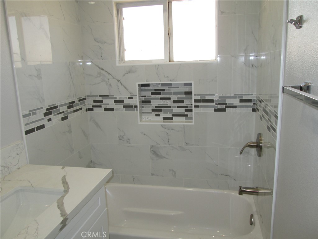 13464 Mohawk Road Apple Valley, CA 92308 - Photo 11 of 35 a bath tub sitting next to a white sink and vanity