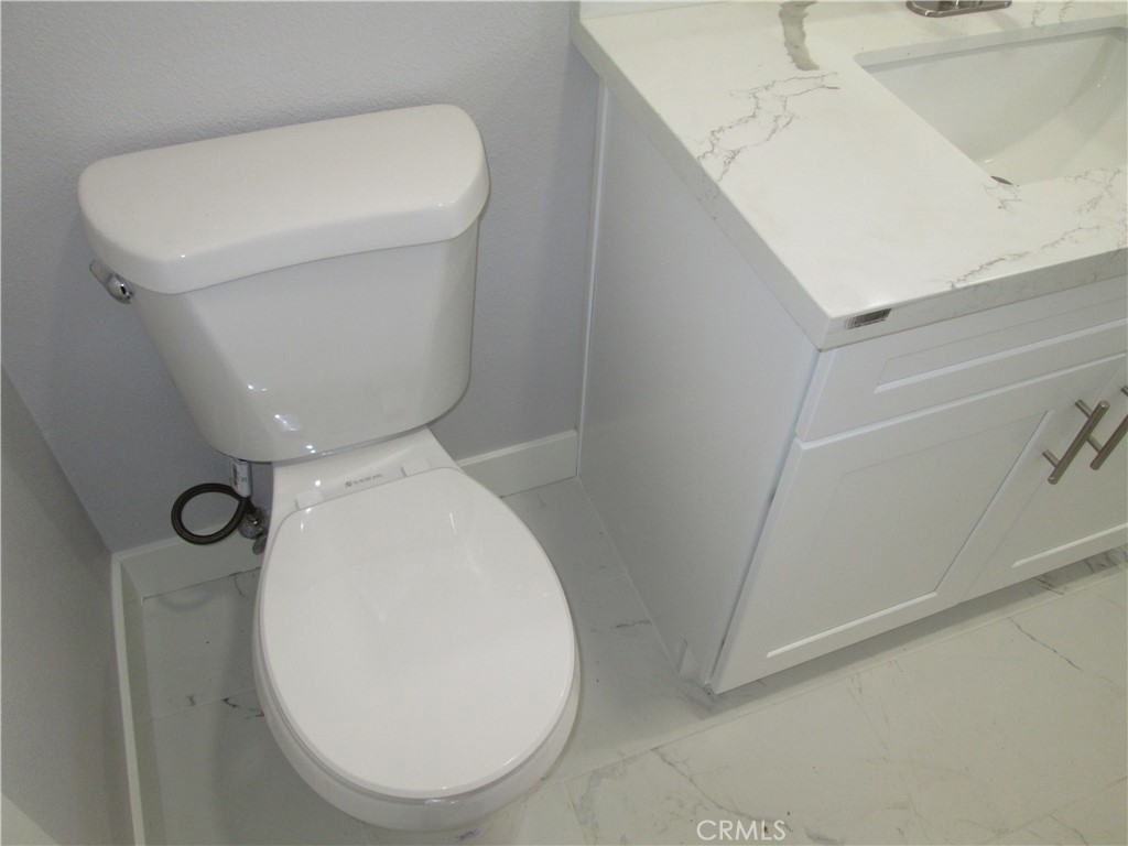 13464 Mohawk Road Apple Valley, CA 92308 - Photo 12 of 35 a bathroom with a toilet and a sink