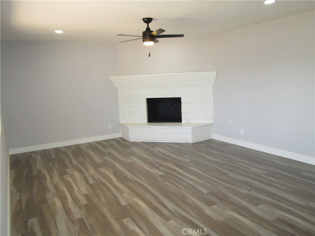 13464 Mohawk Road Apple Valley, CA 92308 - Photo 13 of 35 a view of a room with wooden floor and a ceiling fan