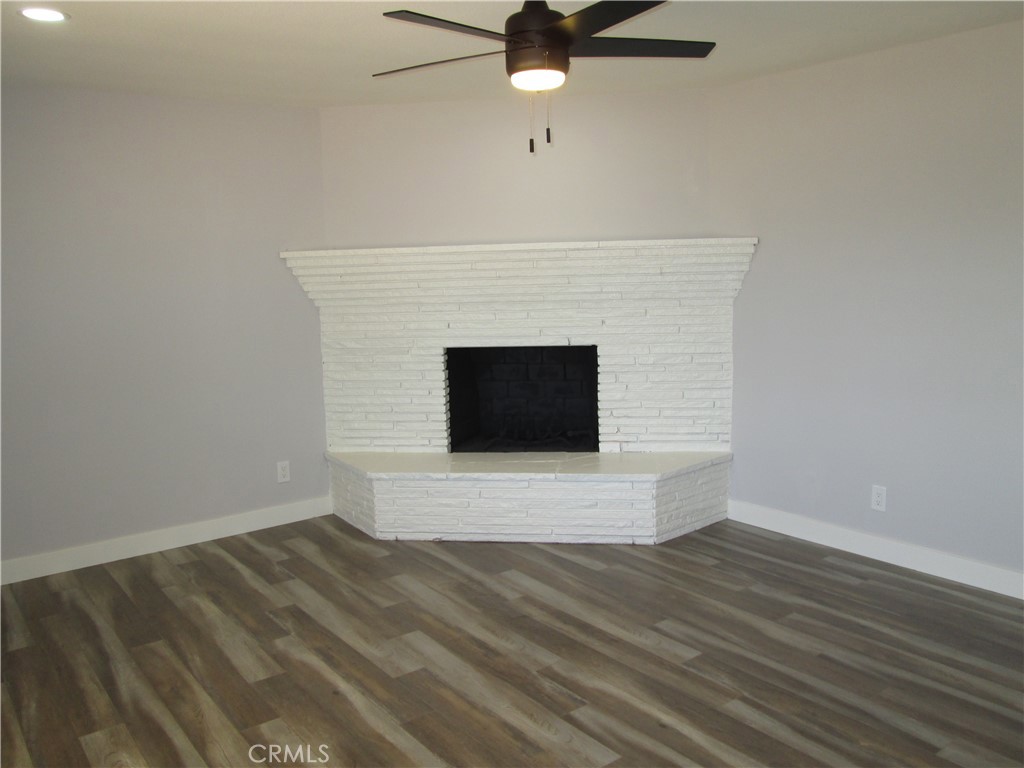 13464 Mohawk Road Apple Valley, CA 92308 - Photo 14 of 35 a view of fireplace and wooden floor
