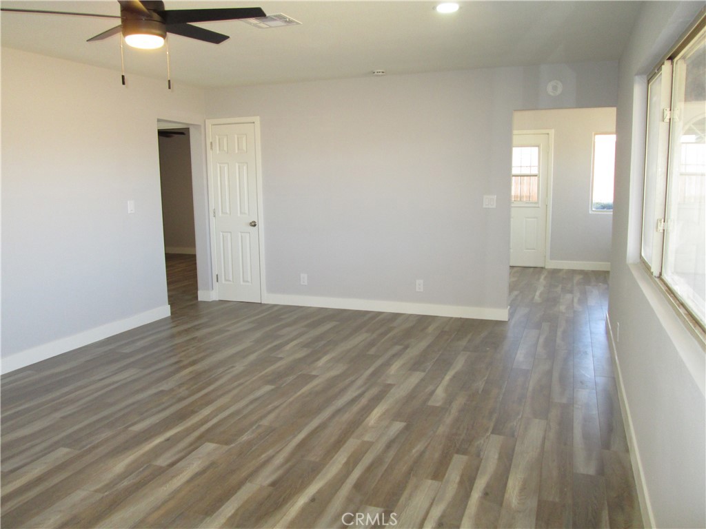 13464 Mohawk Road Apple Valley, CA 92308 - Photo 15 of 35 an empty room with wooden floor and windows