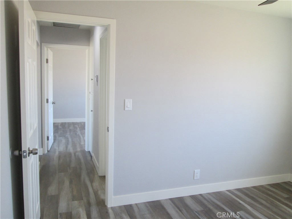 13464 Mohawk Road Apple Valley, CA 92308 - Photo 19 of 35 a view of a room with wooden floor
