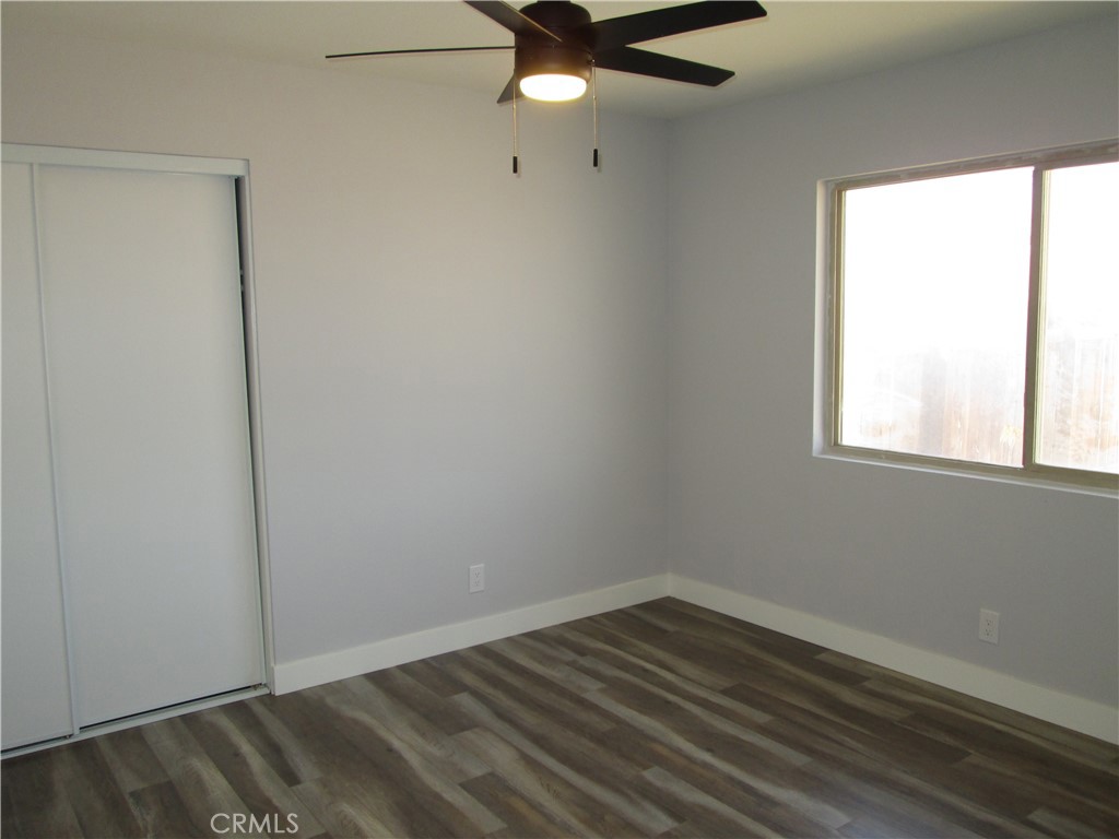13464 Mohawk Road Apple Valley, CA 92308 - Photo 22 of 35 wooden floor in an empty room with a window